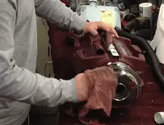 Vacuum repair technician cleaning and servicing a vacuum motor in Fresno, CA